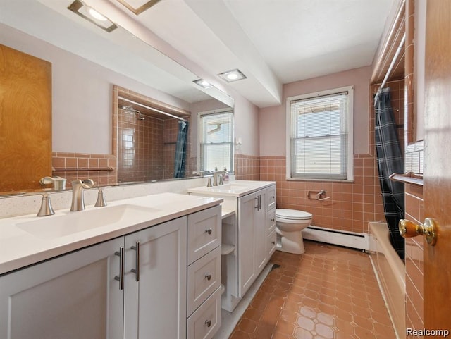 664 Buckingham Ave, Lincoln Park, MI 48146 - bathroom with a baseboard radiator, tile walls, vanity, wainscoting, and tile patterned floors