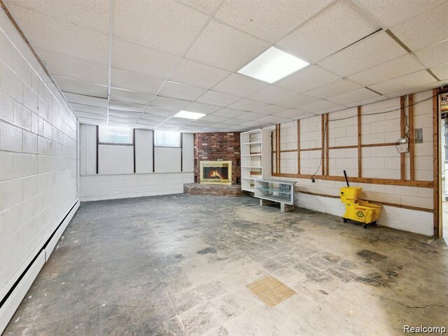 664 Buckingham Ave, Lincoln Park, MI 48146 - garage featuring a baseboard radiator, a brick fireplace, and concrete block wall