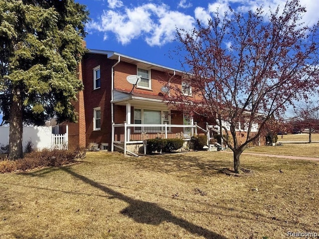 664 Buckingham Ave, Lincoln Park, MI 48146 - rear view of house featuring covered porch and brick siding
