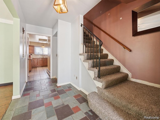 664 Buckingham Ave, Lincoln Park, MI 48146 - staircase featuring baseboards and stone tile flooring