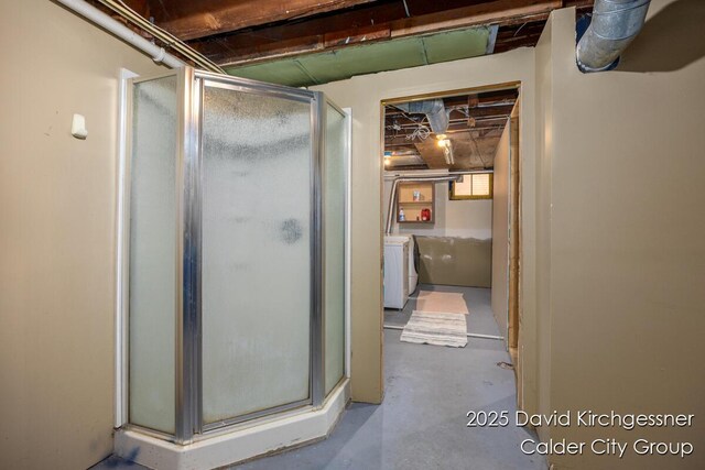 1328 Bemis St SE, Grand Rapids, MI 49506 - full bath with a stall shower, concrete flooring, and washer and clothes dryer