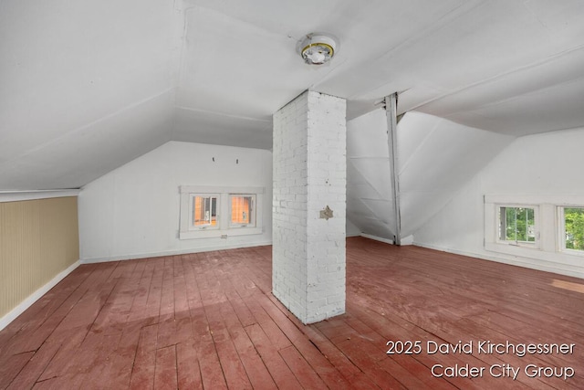 1328 Bemis St SE, Grand Rapids, MI 49506 - additional living space with vaulted ceiling, wood-type flooring, and decorative columns