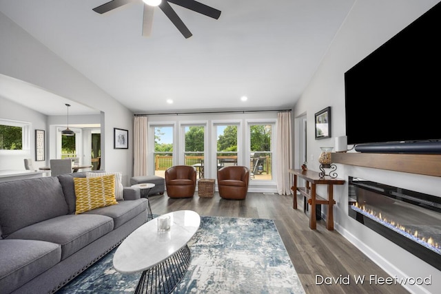6935 Fairway Vista Dr SE, Caledonia, MI 49316 - living area featuring a ceiling fan, wood finished floors, recessed lighting, a glass covered fireplace, and vaulted ceiling
