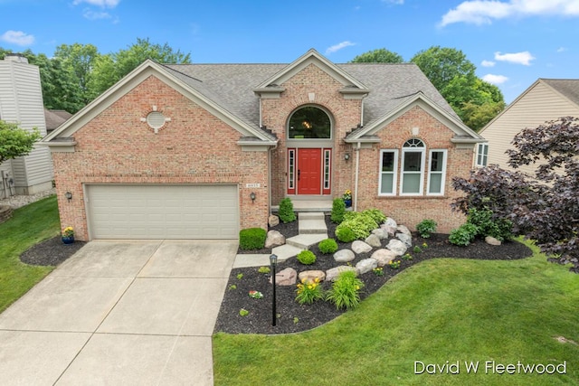 6935 Fairway Vista Dr SE, Caledonia, MI 49316 - traditional-style house with brick siding, a front lawn, concrete driveway, and roof with shingles