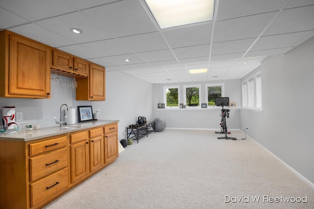 6935 Fairway Vista Dr SE, Caledonia, MI 49316 - kitchen with light colored carpet, light countertops, recessed lighting, a paneled ceiling, and brown cabinetry