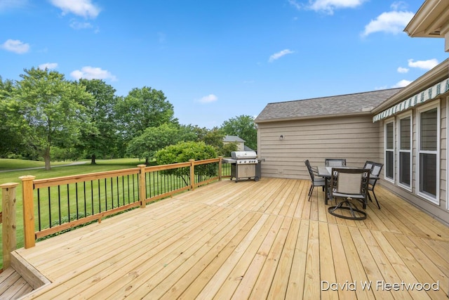 6935 Fairway Vista Dr SE, Caledonia, MI 49316 - deck with area for grilling, outdoor dining area, and a lawn