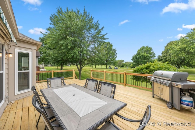 6935 Fairway Vista Dr SE, Caledonia, MI 49316 - wooden deck with outdoor dining space, a grill, and a yard
