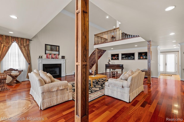 5626 Shadow Ln, Bloomfield Hills, MI 48302 - living room featuring decorative columns, stairs, wood finished floors, healthy amount of natural light, and ornamental molding
