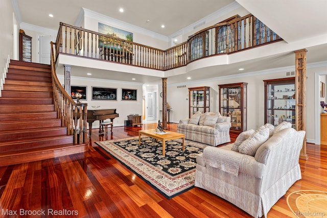 5626 Shadow Ln, Bloomfield Hills, MI 48302 - living area with ornate columns, wood finished floors, stairway, ornamental molding, and a towering ceiling