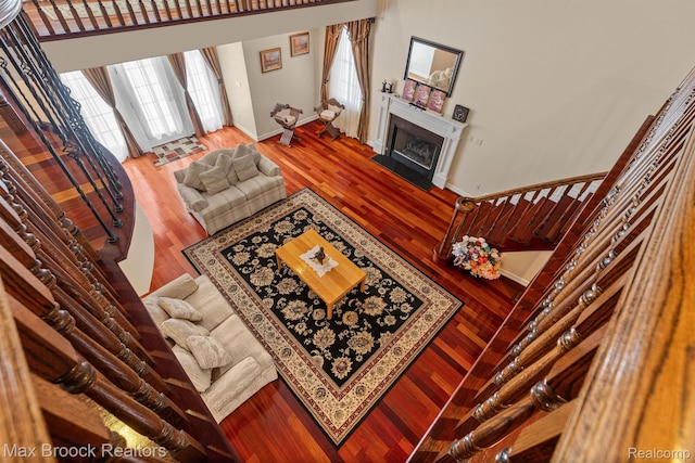 5626 Shadow Ln, Bloomfield Hills, MI 48302 - living room with a fireplace with flush hearth, healthy amount of natural light, wood finished floors, and stairs
