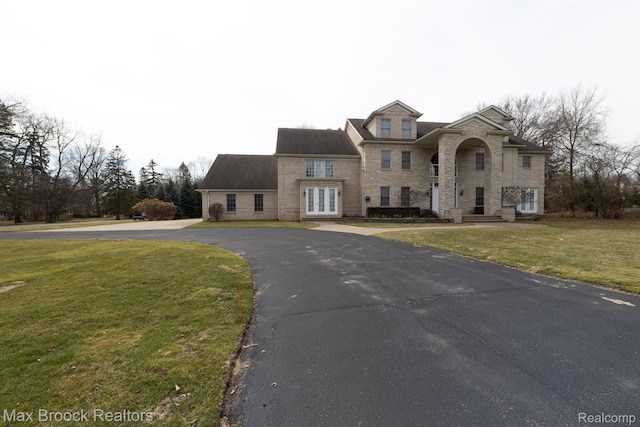 5626 Shadow Ln, Bloomfield Hills, MI 48302 - traditional home with french doors, a front yard, driveway, and stone siding