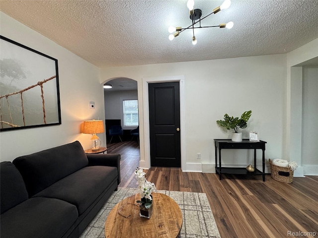 1741 Academy St, Ferndale, MI 48220 - living room with arched walkways, wood finished floors, a textured ceiling, and a chandelier