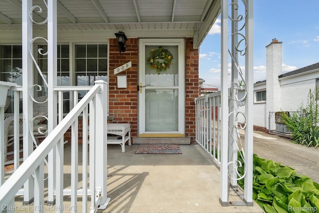 939 Deering St, Garden City, MI 48135 - view of exterior entry featuring brick siding and a porch