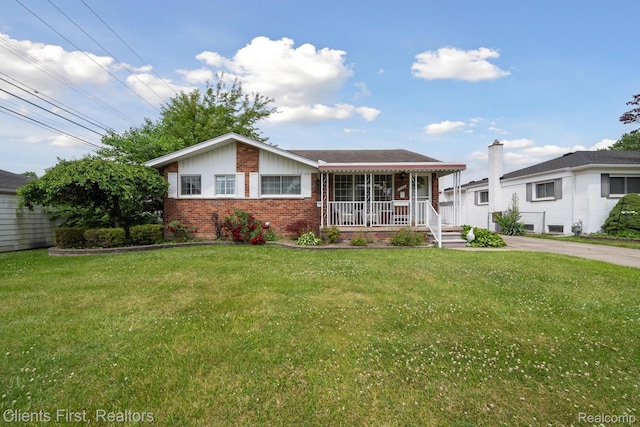 939 Deering St, Garden City, MI 48135 - view of front facade with brick siding, a porch, a front lawn, and driveway