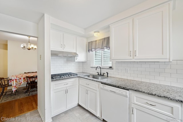 939 Deering St, Garden City, MI 48135 - kitchen featuring white dishwasher, stainless steel gas cooktop, under cabinet range hood, a chandelier, and white cabinetry