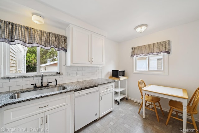 939 Deering St, Garden City, MI 48135 - kitchen with dishwasher, stainless steel microwave, healthy amount of natural light, and backsplash