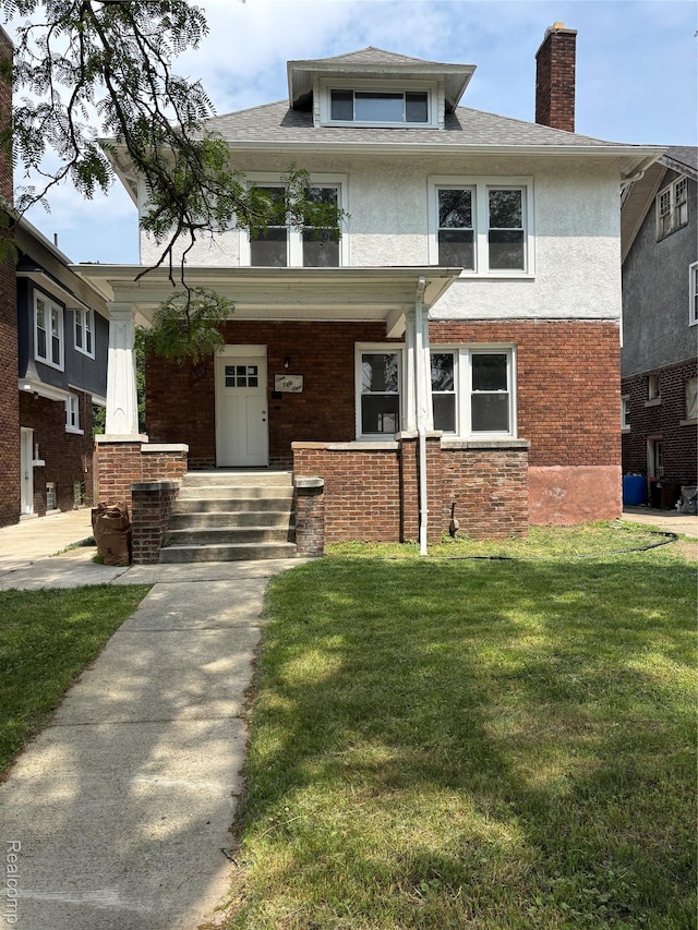151 Mclean St, Highland Park, MI 48203 - american foursquare style home featuring a chimney, a front yard, covered porch, and stucco siding