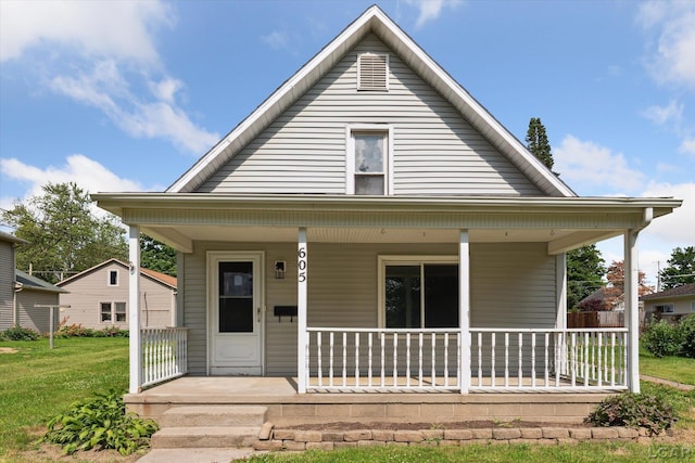 605 Oak St, Hudson, MI 49247 - bungalow featuring a porch and a front lawn