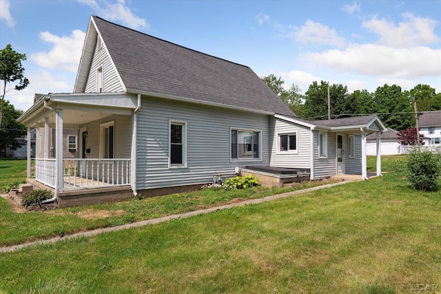 605 Oak St, Hudson, MI 49247 - view of front of house with a front yard, a shingled roof, and covered porch