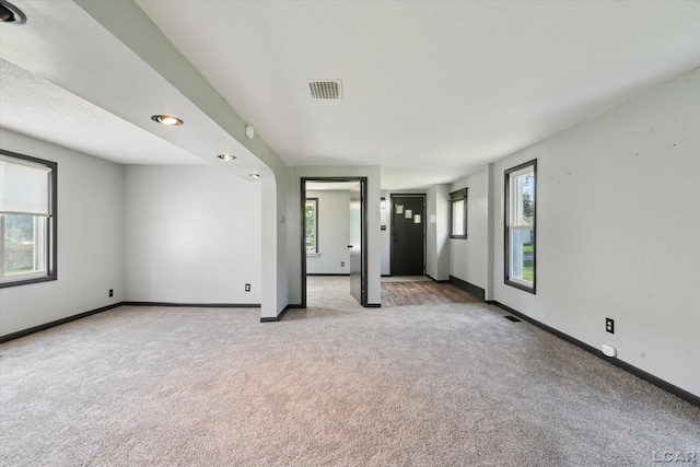 605 Oak St, Hudson, MI 49247 - spare room featuring light carpet and baseboards
