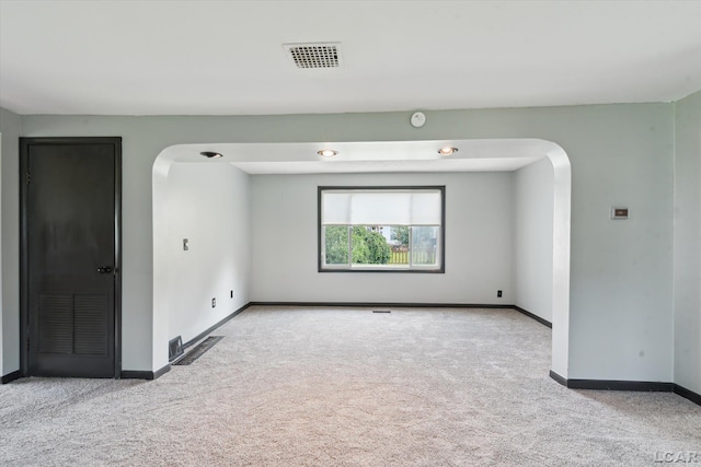 605 Oak St, Hudson, MI 49247 - carpeted spare room with arched walkways and a smoke detector