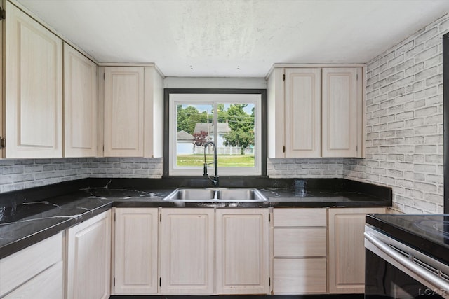 605 Oak St, Hudson, MI 49247 - kitchen featuring light brown cabinetry, dark countertops, and range with electric stovetop