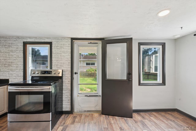 605 Oak St, Hudson, MI 49247 - doorway with baseboards and light wood-style flooring