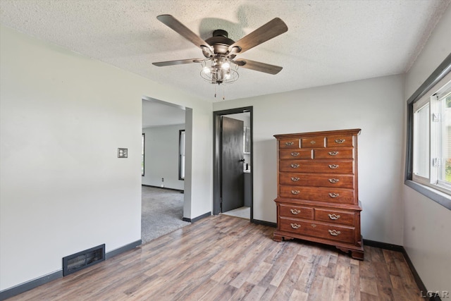 605 Oak St, Hudson, MI 49247 - bedroom featuring light wood finished floors, a textured ceiling, and a ceiling fan