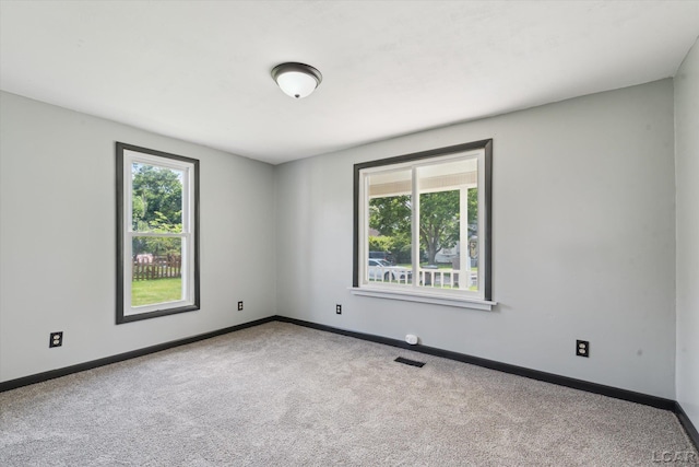 605 Oak St, Hudson, MI 49247 - carpeted empty room with baseboards