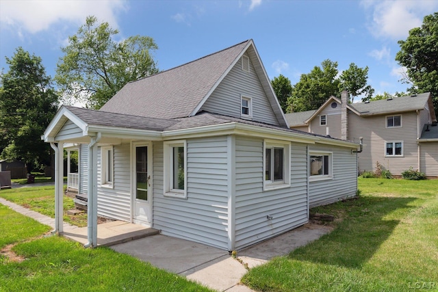 605 Oak St, Hudson, MI 49247 - view of property exterior featuring a yard and roof with shingles