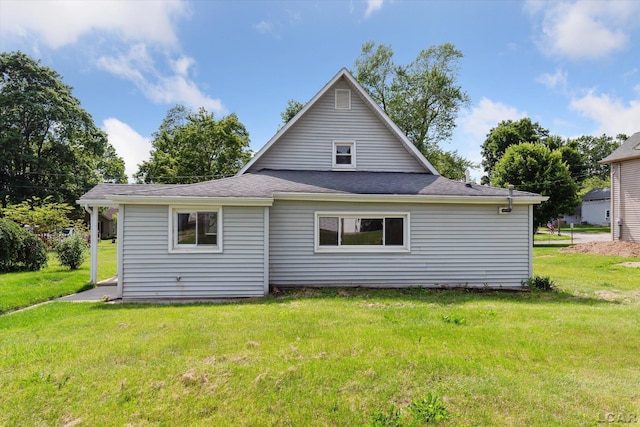 605 Oak St, Hudson, MI 49247 - back of property featuring a lawn and roof with shingles