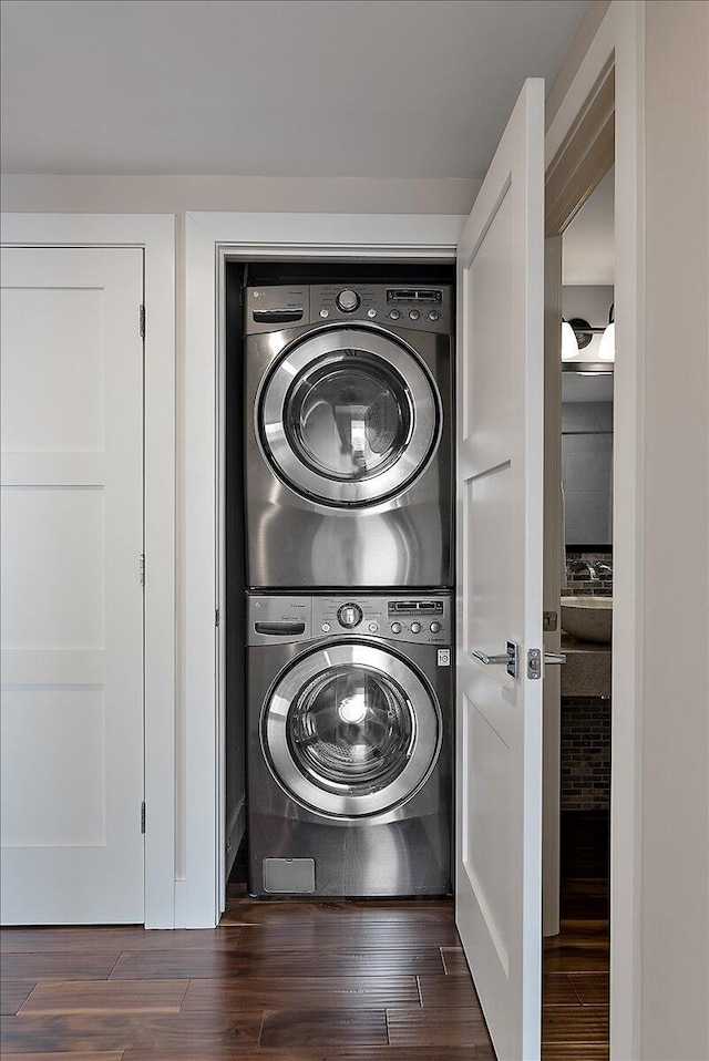 43 Campau Cir NW, Grand Rapids, MI 49503 - laundry room featuring stacked washer / drying machine and dark wood-style flooring