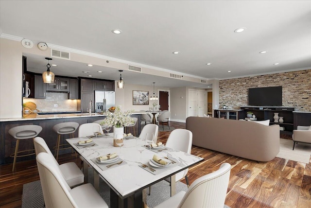 43 Campau Cir NW, Grand Rapids, MI 49503 - dining space with crown molding, wood finished floors, and recessed lighting