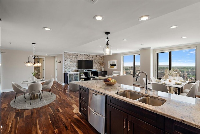 43 Campau Cir NW, Grand Rapids, MI 49503 - kitchen featuring dark wood-type flooring, stainless steel dishwasher, pendant lighting, recessed lighting, and light stone countertops