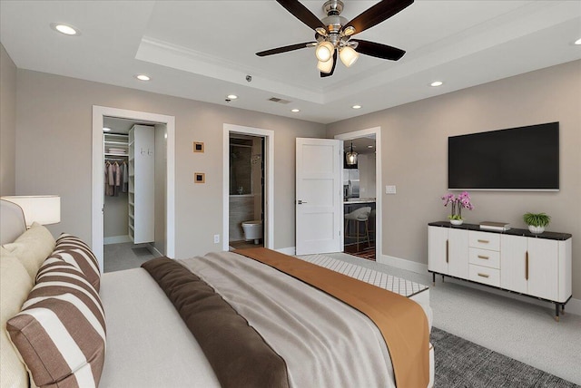 43 Campau Cir NW, Grand Rapids, MI 49503 - carpeted bedroom featuring a raised ceiling, recessed lighting, ornamental molding, a spacious closet, and ensuite bathroom