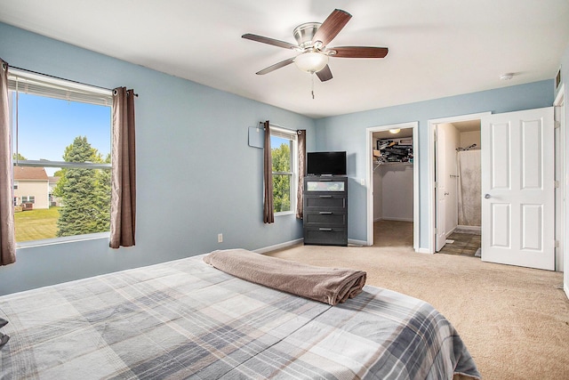 8855 Geiser Grv, Richland, MI 49083 - bedroom with a walk in closet, a closet, light colored carpet, ceiling fan, and ensuite bathroom