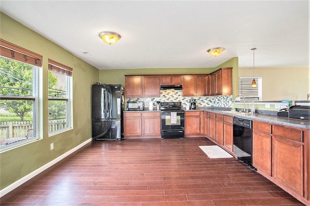 8855 Geiser Grv, Richland, MI 49083 - kitchen with black appliances, backsplash, brown cabinets, pendant lighting, and dark wood-style flooring