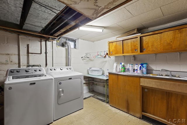 1043 Orchard Rd, Adrian, MI 49221 - washroom with cabinet space, washer and dryer, light floors, and concrete block wall