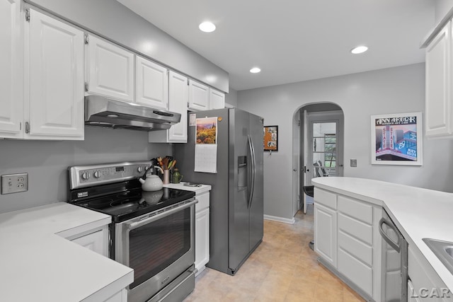 1043 Orchard Rd, Adrian, MI 49221 - kitchen featuring appliances with stainless steel finishes, under cabinet range hood, arched walkways, white cabinets, and light countertops