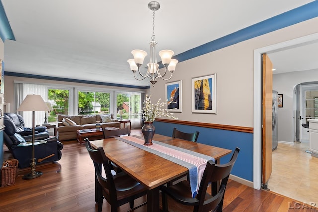 1043 Orchard Rd, Adrian, MI 49221 - dining room with a chandelier, wood finished floors, and arched walkways