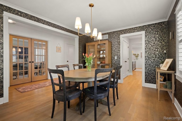 423 N Altadena Ave, Royal Oak, MI 48067 - dining area with wallpapered walls, french doors, light wood finished floors, crown molding, and a chandelier