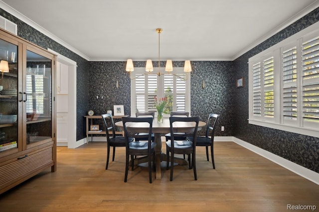 423 N Altadena Ave, Royal Oak, MI 48067 - dining room with wallpapered walls, crown molding, wood finished floors, and a chandelier