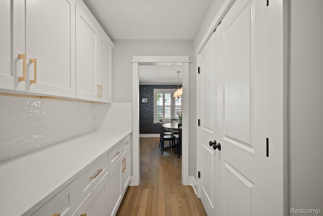 423 N Altadena Ave, Royal Oak, MI 48067 - hallway featuring wood finished floors and a chandelier