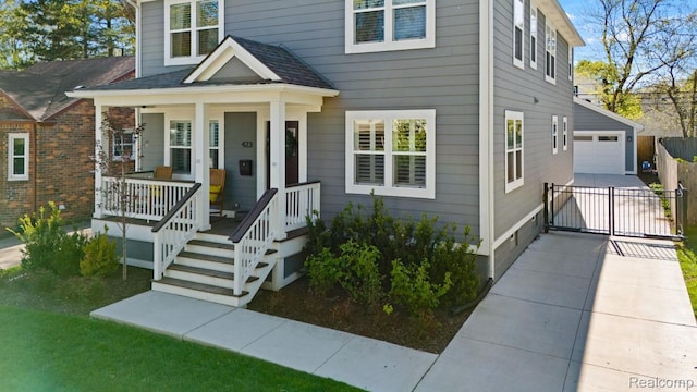 423 N Altadena Ave, Royal Oak, MI 48067 - view of front of home featuring covered porch, an outdoor structure, a shingled roof, and a detached garage