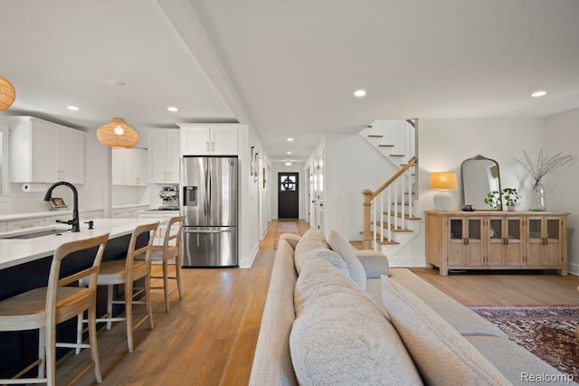 423 N Altadena Ave, Royal Oak, MI 48067 - living room with recessed lighting, light wood finished floors, and stairway