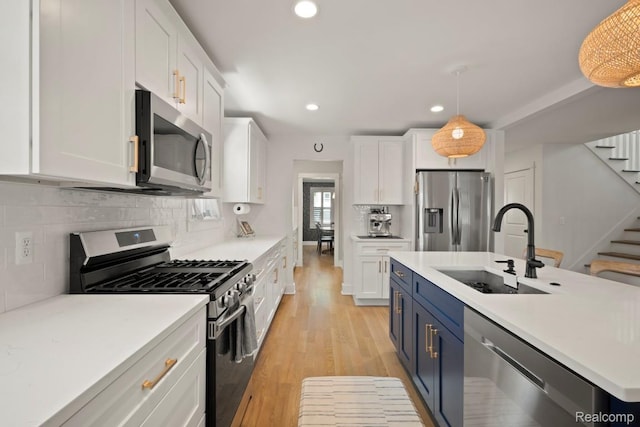 423 N Altadena Ave, Royal Oak, MI 48067 - kitchen with stainless steel appliances, blue cabinets, white cabinets, and recessed lighting