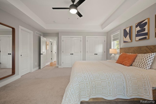 423 N Altadena Ave, Royal Oak, MI 48067 - bedroom featuring a raised ceiling, two closets, light carpet, and ceiling fan