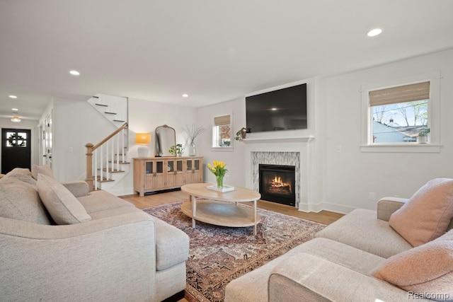 423 N Altadena Ave, Royal Oak, MI 48067 - living room featuring healthy amount of natural light, recessed lighting, wood finished floors, a warm lit fireplace, and stairway
