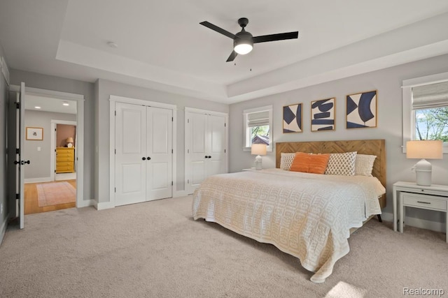 423 N Altadena Ave, Royal Oak, MI 48067 - bedroom with two closets, light carpet, a raised ceiling, multiple windows, and recessed lighting