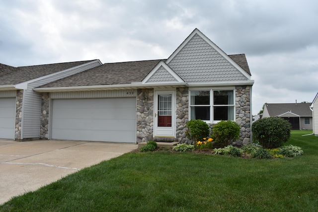 439 Obrian, Milan, MI 48160 - victorian home with stone siding, an attached garage, a front yard, driveway, and a shingled roof